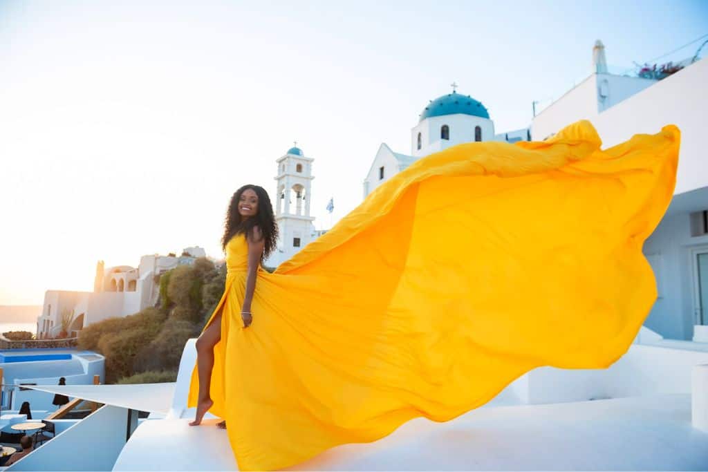 Myself doing a rooftop photo shoot with a blue domed church background.