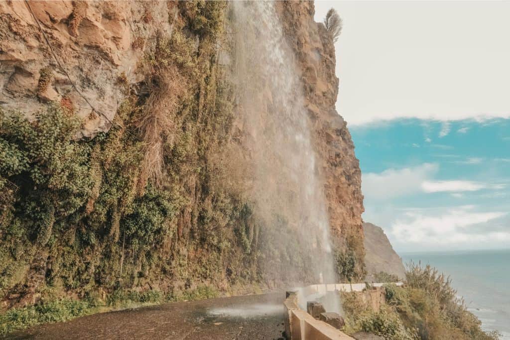 Cascata dos Anjos is a waterfall pouring over the street.