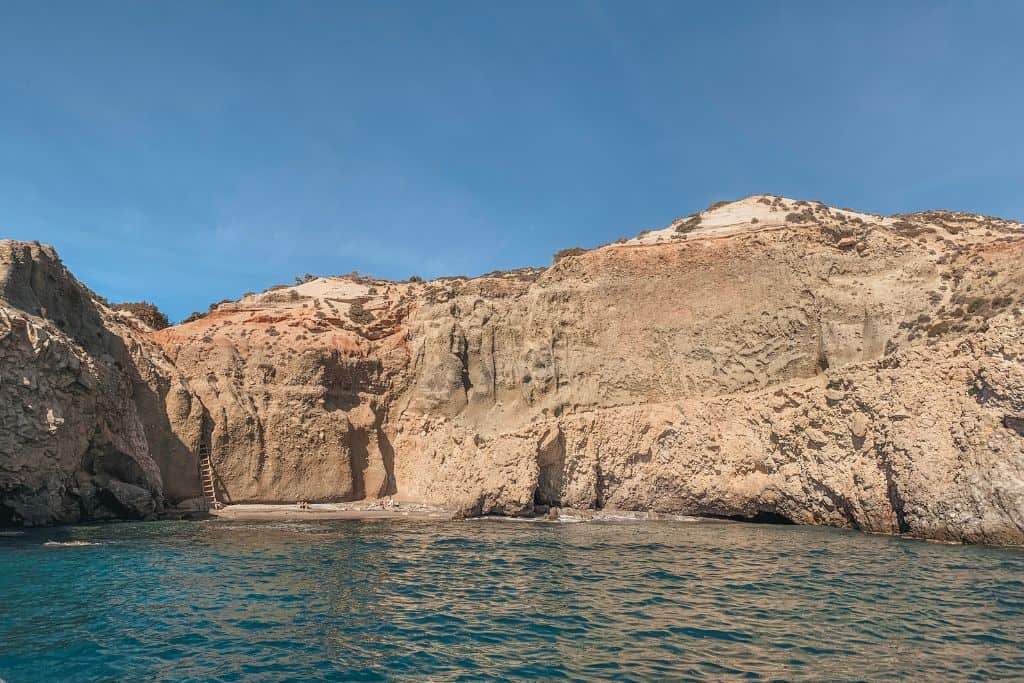 Tsigrado is a unique beach in Milos because you have to use a rope and ladder to reach it by foot.